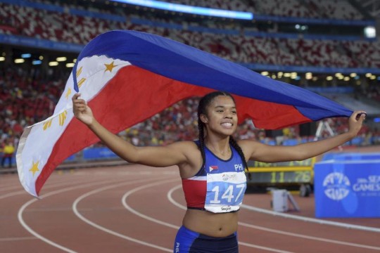 Kayla Anise Richardson of the Philippines celebrates her win in the women's 100-meter final at the SEA Games in Singapore Tuesday, June 9, 2015.(AP Photo/Joseph Nair)