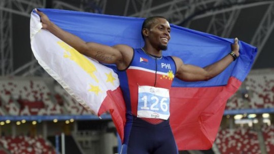 Eric Shauwn Cray of the Philippines celebrates after winning the men's 100-meter final at the SEA Games in Singapore Tuesday, June 9, 2015. (AP Photo/Joseph Nair)