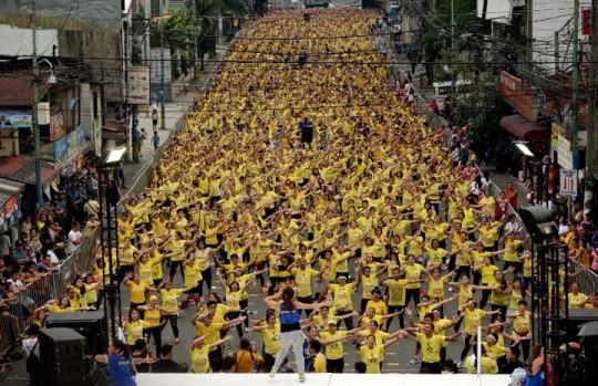 Filipino residents participate in a Zumba class in an attempt to break the Guinness World Record in Mandaluyong on July 19, 2015. Residents broke the record for the largest Zumba class with 12,975 participants in a single venue. AFP PHOTO / NOEL CELIS