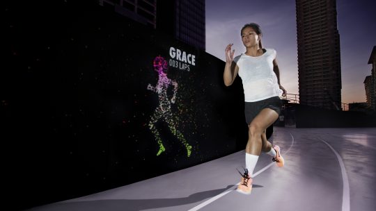 Nike Run Club Coach Ian Banzon outpacing his avatar at the Unlimited Stadium